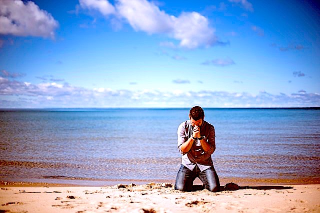 praying on beach